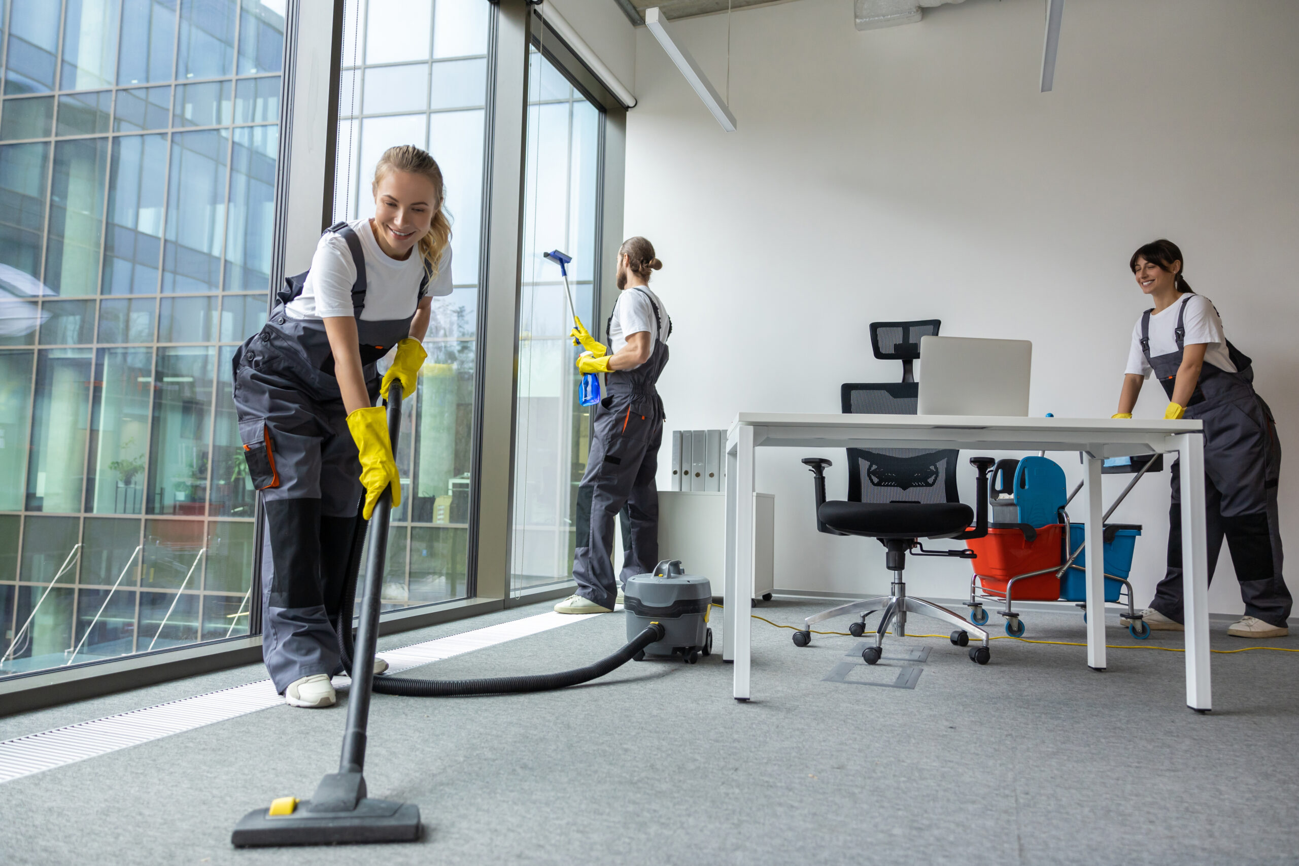 Housekeeping Team Cleaning Conference Room Looking Busy Involved Scaled