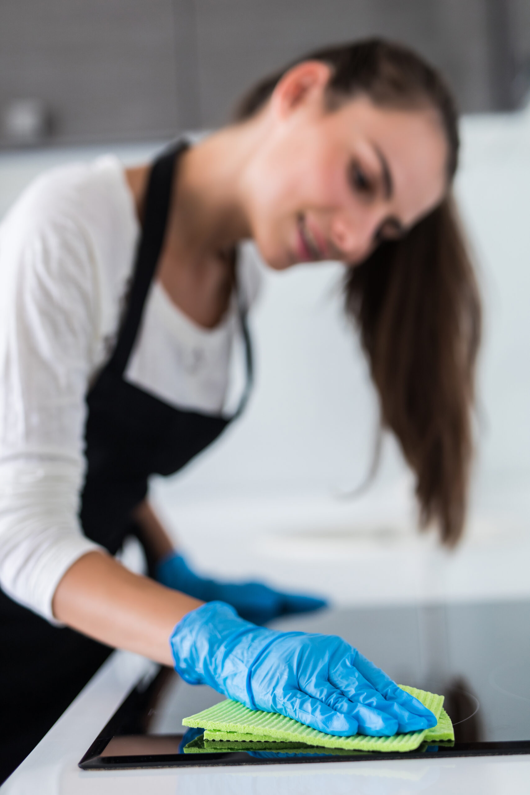 beautiful woman doing the housework while cleaning in the kitchen